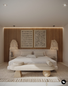 A white bed with wood paneling behind the headboard.