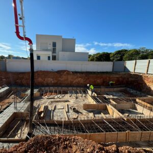 Construction workers pouring the cement foundation for Marina Residence 45